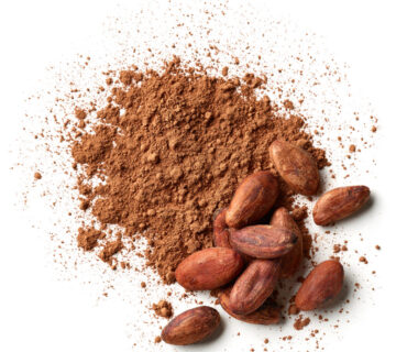 Heap of cocoa powder and beans isolated on white background Why Pastino Alkalized Cocoa Powder Improves Flavor and Color