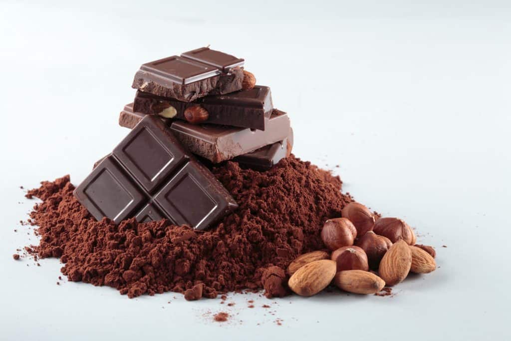 How does cocoa powder influence chocolate viscosity?