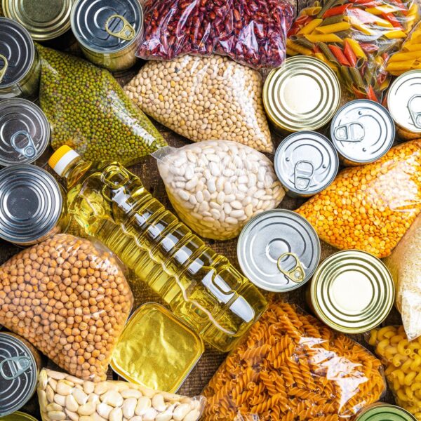 Donations food with canned food on the table background. Donate concept. Long Term Supplier Germany Food Industry